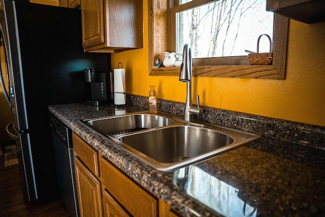 33902 County Rd N Unit L4, Hillpoint, WI 53937 - kitchen featuring a sink, dishwasher, brown cabinets, and freestanding refrigerator