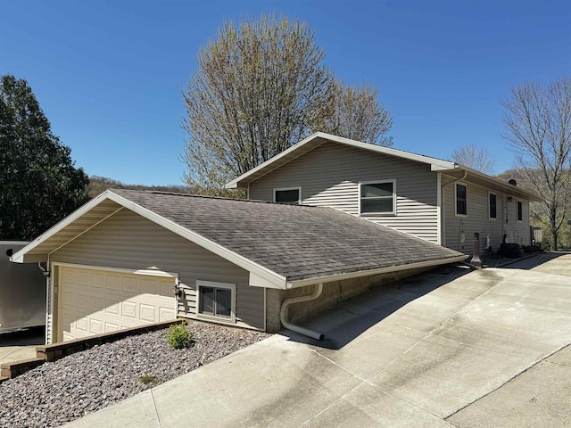 33902 County Rd N Unit L4, Hillpoint, WI 53937 - view of side of property featuring roof with shingles, a garage, and driveway
