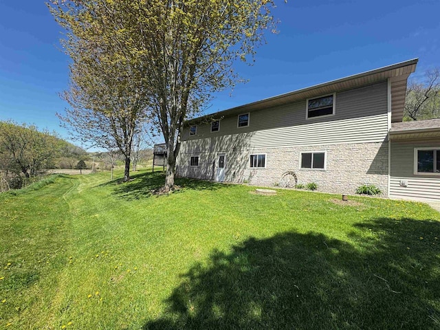 33902 County Rd N Unit L4, Hillpoint, WI 53937 - rear view of property with a yard and stone siding