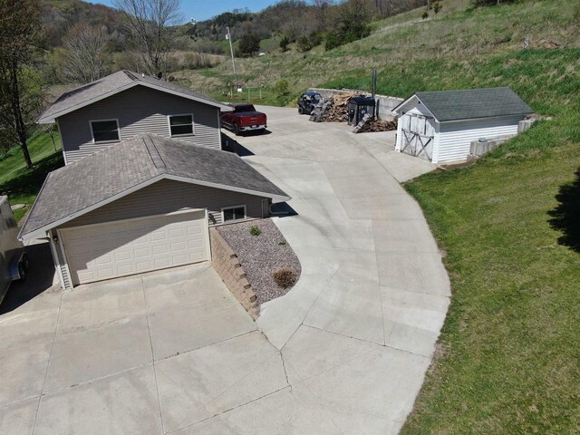 33902 County Rd N Unit L4, Hillpoint, WI 53937 - view of front of property featuring concrete driveway, a front lawn, an outbuilding, and a storage unit
