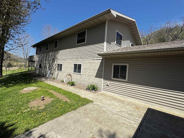 33902 County Rd N Unit L4, Hillpoint, WI 53937 - back of property with a lawn, stone siding, and a patio area
