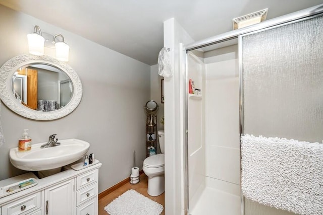 226 N Main St Unit 6, Walworth, WI 53184 - full bath featuring a stall shower, toilet, wood finished floors, vanity, and baseboards