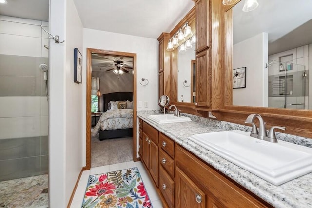 226 N Main St Unit 6, Walworth, WI 53184 - ensuite bathroom featuring a stall shower, ceiling fan, double vanity, tile patterned flooring, and baseboards