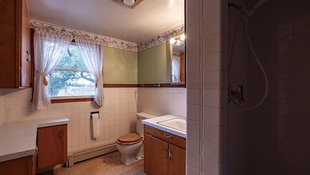 N2145 Lind Center Rd, Waupaca, WI 54981 - full bathroom with a baseboard radiator, vanity, a tile shower, tile walls, and toilet