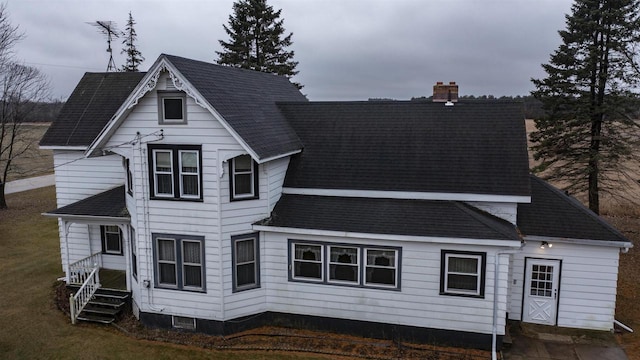 N2145 Lind Center Rd, Waupaca, WI 54981 - back of property featuring a chimney, a shingled roof, and a yard