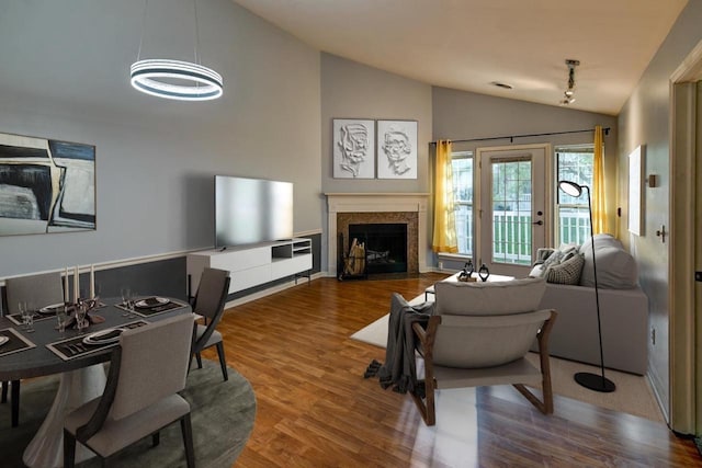 7102 Flagship Dr Unit 8, Madison, WI 53719 - living room with lofted ceiling, wood finished floors, a fireplace with flush hearth, and a chandelier
