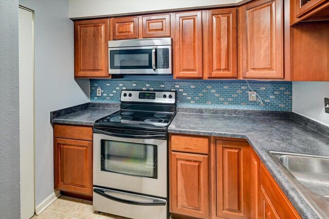7102 Flagship Dr Unit 8, Madison, WI 53719 - kitchen featuring stainless steel appliances, dark countertops, and tasteful backsplash