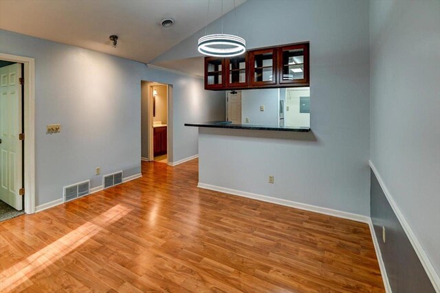 7102 Flagship Dr Unit 8, Madison, WI 53719 - spare room featuring lofted ceiling, baseboards, and light wood-style floors