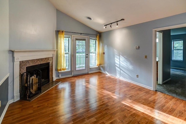 7102 Flagship Dr Unit 8, Madison, WI 53719 - unfurnished living room featuring lofted ceiling, baseboards, wood finished floors, a fireplace, and track lighting