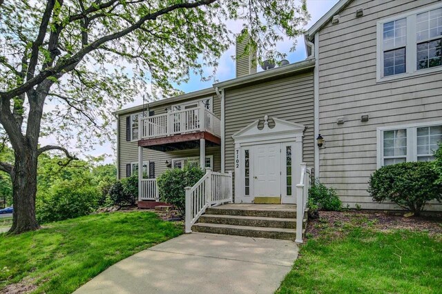 7102 Flagship Dr Unit 8, Madison, WI 53719 - view of front of house with a chimney, a balcony, and a front lawn