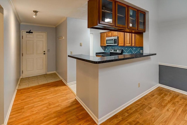 7102 Flagship Dr Unit 8, Madison, WI 53719 - kitchen with appliances with stainless steel finishes, light wood-style flooring, ornamental molding, brown cabinets, and glass insert cabinets