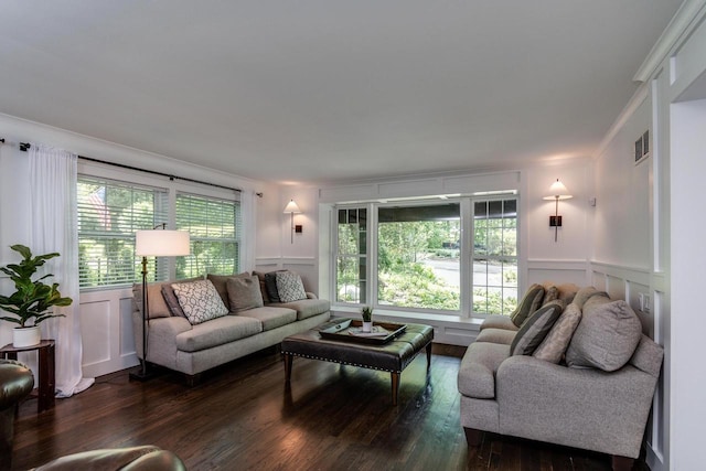 810 Farwell Dr, Madison, WI 53704 - living room featuring dark wood-style floors, plenty of natural light, a decorative wall, a wainscoted wall, and ornamental molding