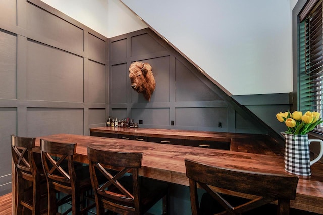810 Farwell Dr, Madison, WI 53704 - bar featuring a decorative wall and wood finished floors