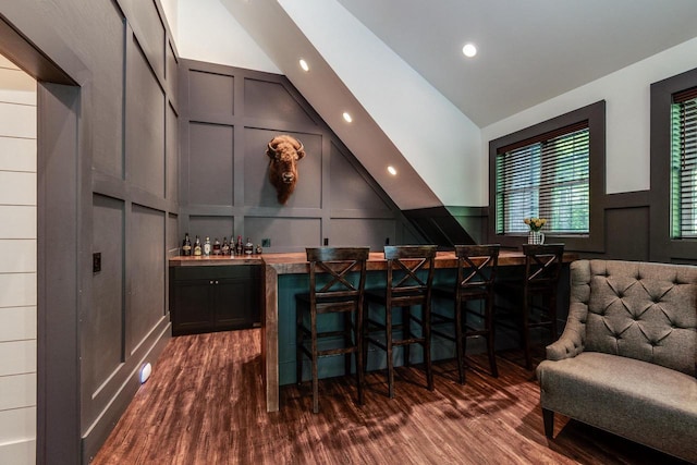 810 Farwell Dr, Madison, WI 53704 - indoor dry bar featuring a decorative wall, dark wood-style flooring, lofted ceiling, and recessed lighting