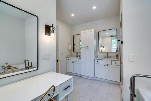 810 Farwell Dr, Madison, WI 53704 - bathroom featuring recessed lighting, two vanities, and a tub