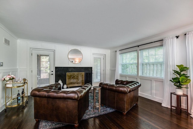 810 Farwell Dr, Madison, WI 53704 - living area with a decorative wall, dark wood-style flooring, crown molding, and a fireplace