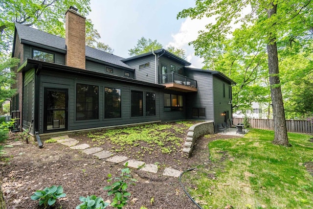 810 Farwell Dr, Madison, WI 53704 - rear view of property with a chimney, a balcony, fence, and a patio