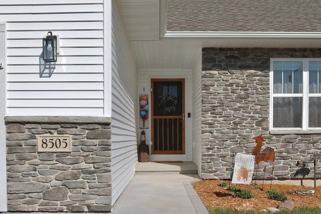 8505 Hinner Springs Dr, Weston, WI 54476 - property entrance featuring stone siding and a shingled roof