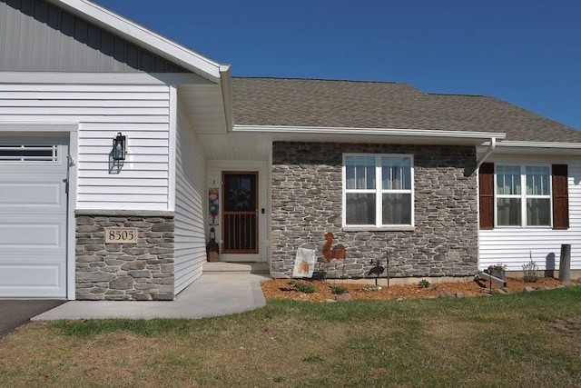 8505 Hinner Springs Dr, Weston, WI 54476 - entrance to property featuring stone siding, a lawn, a garage, and a shingled roof