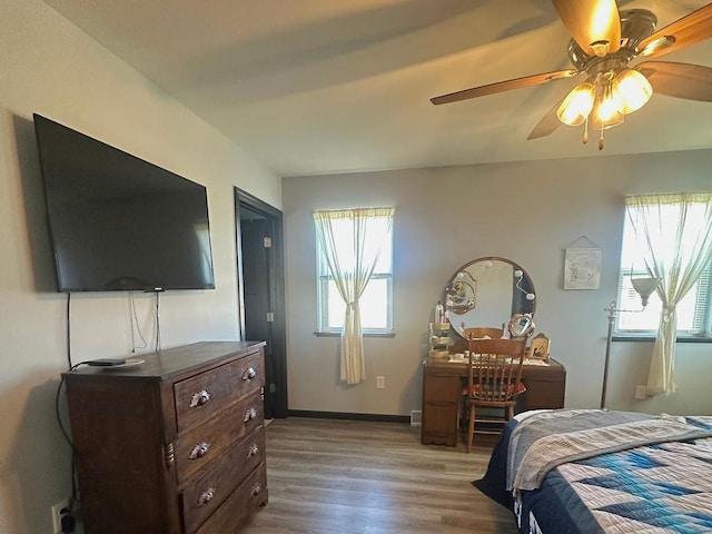 8505 Hinner Springs Dr, Weston, WI 54476 - bedroom featuring multiple windows, wood finished floors, a ceiling fan, and baseboards
