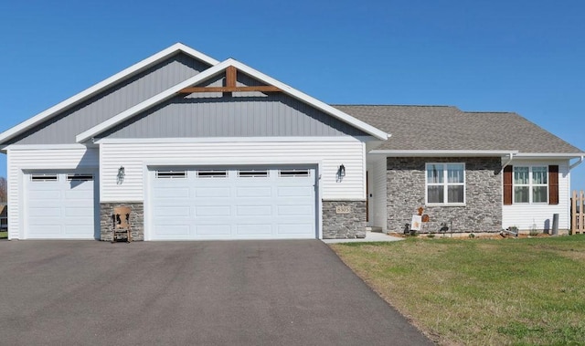 8505 Hinner Springs Dr, Weston, WI 54476 - craftsman inspired home with stone siding, asphalt driveway, a garage, and a front lawn