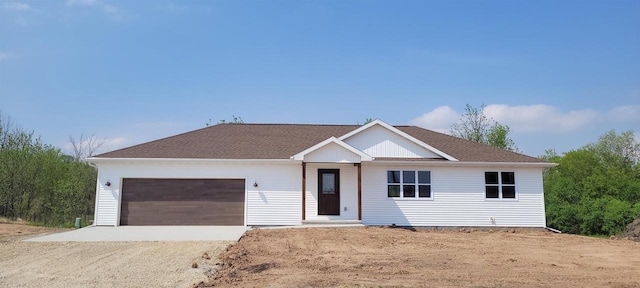 629 Douglas St, New London, WI 54961 - view of front of property featuring dirt driveway, an attached garage, and a shingled roof