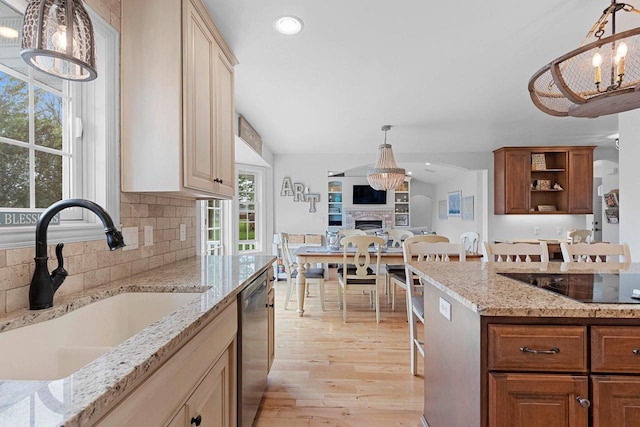 2074 Sandy Springs Rd, De Pere, WI 54115 - kitchen with a sink, black electric stovetop, stainless steel dishwasher, light wood-style flooring, and a chandelier