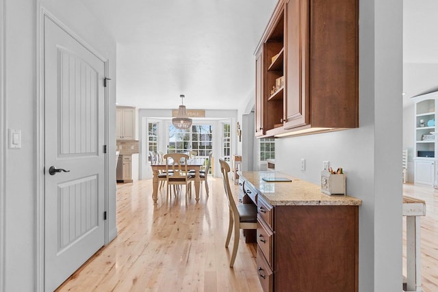 2074 Sandy Springs Rd, De Pere, WI 54115 - kitchen featuring light wood-style floors, open shelves, light stone countertops, and hanging light fixtures
