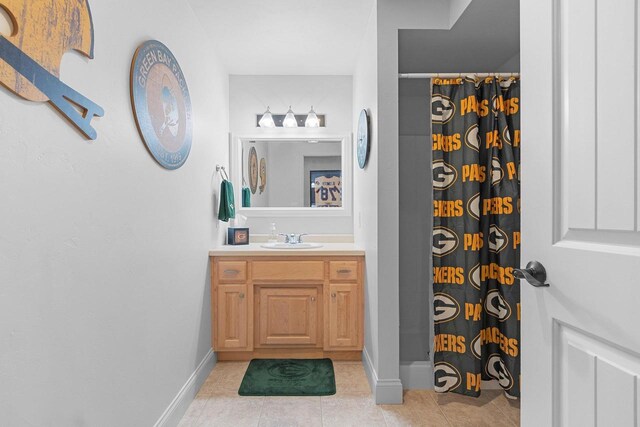 2074 Sandy Springs Rd, De Pere, WI 54115 - full bathroom featuring tile patterned floors, a shower with curtain, vanity, and baseboards