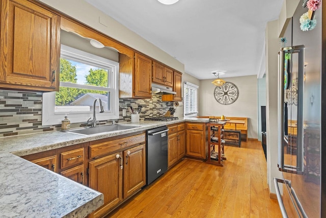 1333 W Lawrence St, Appleton, WI 54914 - kitchen with appliances with stainless steel finishes, a sink, brown cabinets, and light countertops