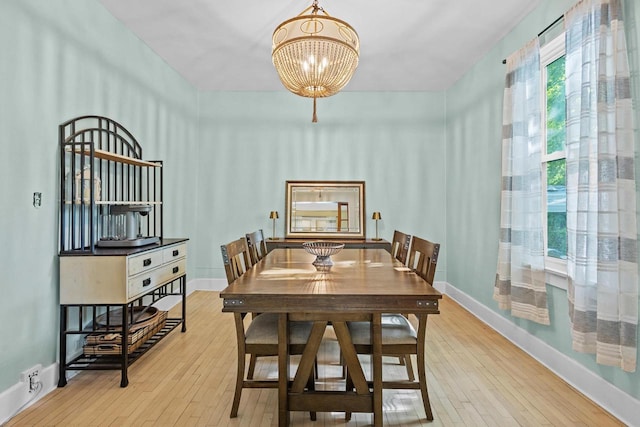 1333 W Lawrence St, Appleton, WI 54914 - dining room with a chandelier, hardwood / wood-style flooring, and baseboards