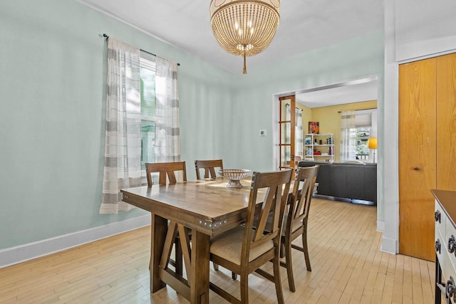 1333 W Lawrence St, Appleton, WI 54914 - dining space with light wood-style flooring, a chandelier, and baseboards