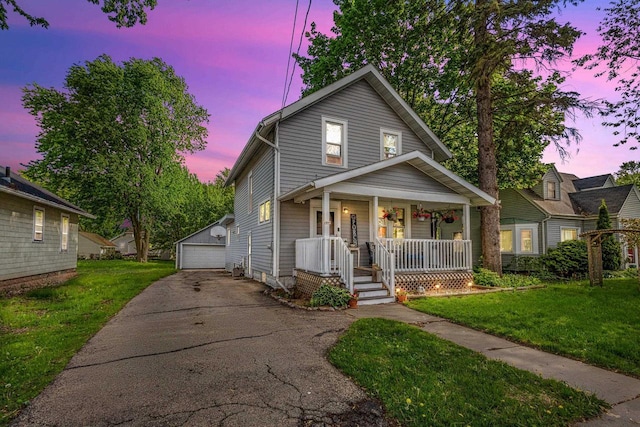 1333 W Lawrence St, Appleton, WI 54914 - view of front of home with a porch, an outbuilding, a detached garage, and a front lawn