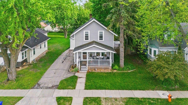 1333 W Lawrence St, Appleton, WI 54914 - view of front of home with a porch, asphalt driveway, a front yard, and a chimney