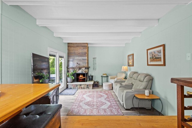 1333 W Lawrence St, Appleton, WI 54914 - living area with beamed ceiling, wood finished floors, a fireplace, and wooden walls