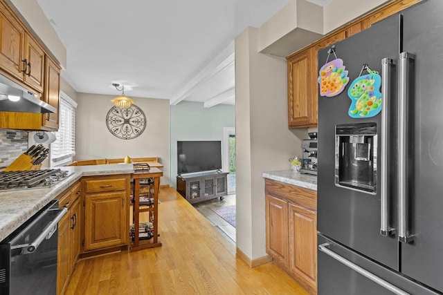 1333 W Lawrence St, Appleton, WI 54914 - kitchen with appliances with stainless steel finishes, light wood-style floors, brown cabinets, and light countertops