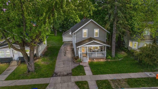 1333 W Lawrence St, Appleton, WI 54914 - view of front of property featuring a porch, an outbuilding, a front yard, and a garage