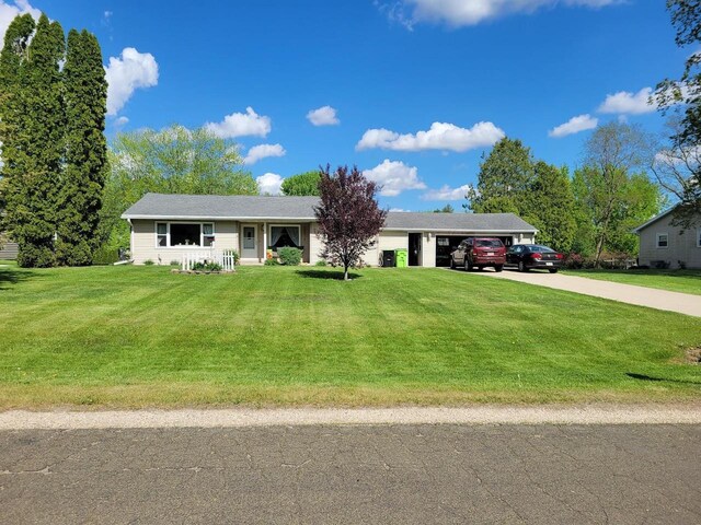 N4516 Hazelwood Rd, Hustisford, WI 53034 - single story home with concrete driveway, a garage, a front lawn, and covered porch