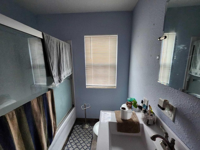 805 S Wacouta Ave, Prairie Du Chien, WI 53821 - full bathroom with toilet, a textured wall, and combined bath / shower with glass door