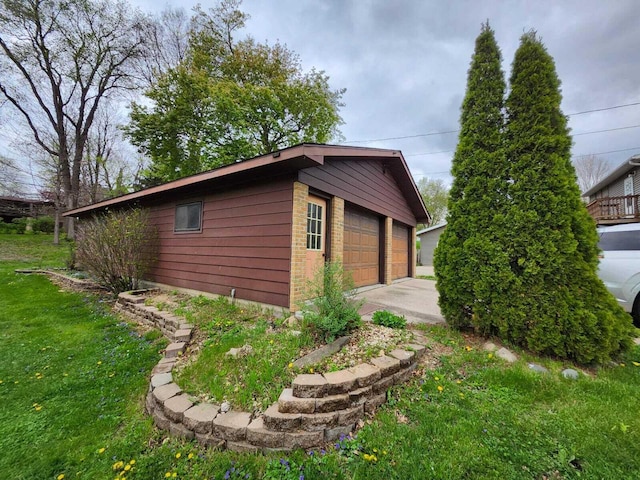 805 S Wacouta Ave, Prairie Du Chien, WI 53821 - view of home's exterior with an outdoor structure, a detached garage, and a lawn