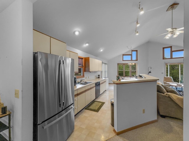 911 Fawn Ln, Port Edwards, WI 54469 - kitchen with freestanding refrigerator, dishwashing machine, cream cabinetry, light countertops, and open floor plan