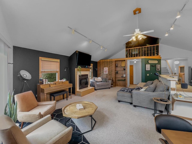 911 Fawn Ln, Port Edwards, WI 54469 - carpeted living room featuring rail lighting, vaulted ceiling, ceiling fan, stairway, and a glass covered fireplace
