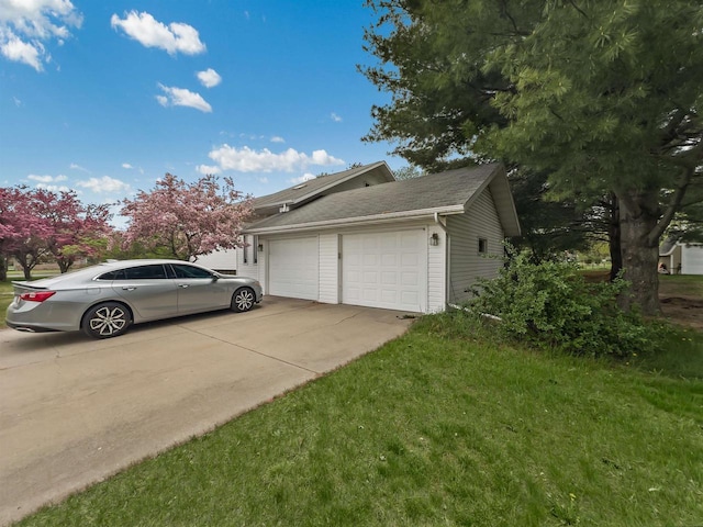 911 Fawn Ln, Port Edwards, WI 54469 - view of side of property with an attached garage, concrete driveway, and a lawn