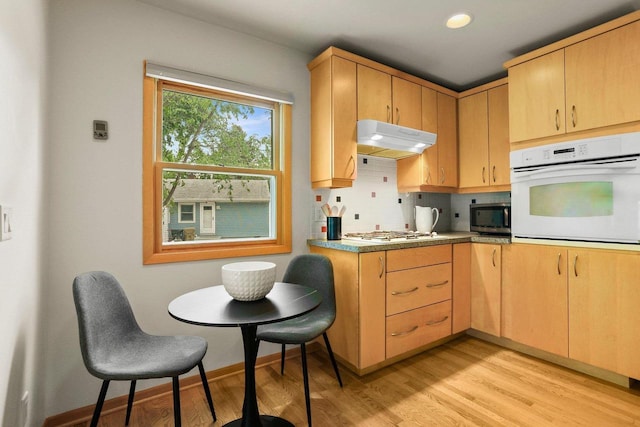 5406 Marsha Dr, Madison, WI 53705 - kitchen featuring white appliances, under cabinet range hood, light wood-type flooring, and light brown cabinets