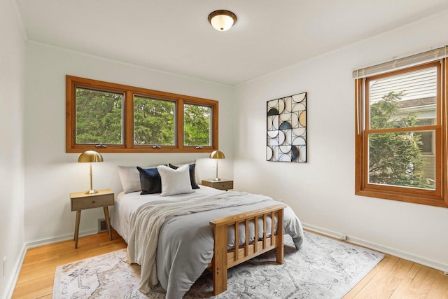 5406 Marsha Dr, Madison, WI 53705 - bedroom featuring multiple windows, wood finished floors, and baseboards
