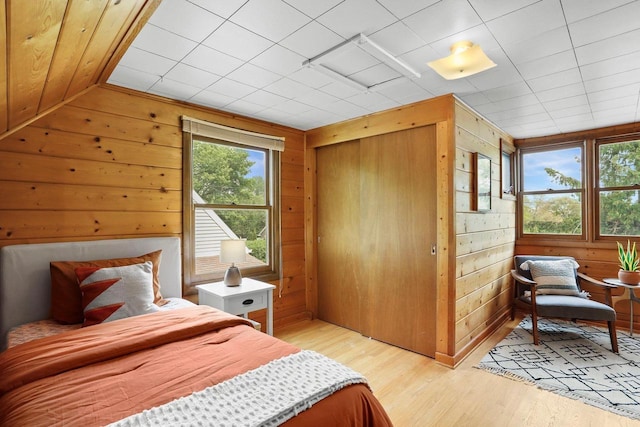 5406 Marsha Dr, Madison, WI 53705 - bedroom with wood walls, light wood-style floors, and a closet