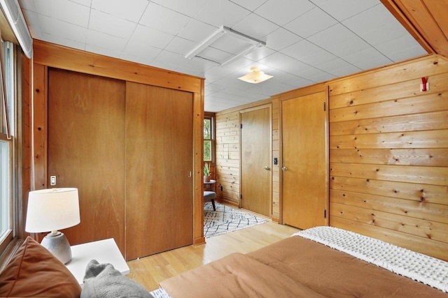 5406 Marsha Dr, Madison, WI 53705 - bedroom with light wood finished floors, wood walls, and multiple closets