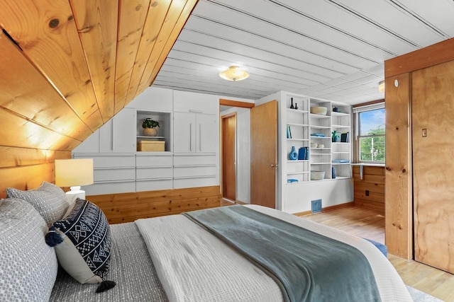 5406 Marsha Dr, Madison, WI 53705 - bedroom featuring light wood-style flooring, wooden ceiling, vaulted ceiling, and wooden walls