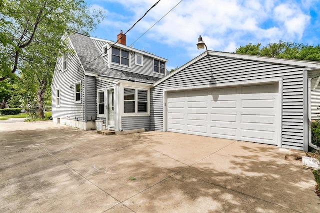 5406 Marsha Dr, Madison, WI 53705 - view of front of house with a shingled roof, a garage, a chimney, and concrete driveway
