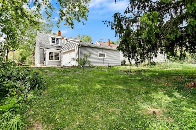 5406 Marsha Dr, Madison, WI 53705 - back of property with a garage and a chimney
